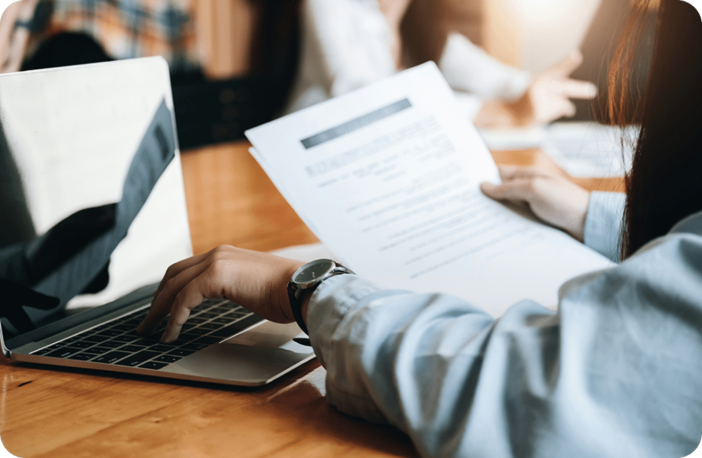 How to Verify a Cash Home Buyer Is Legitimate: Step-by-Step Checklist 4 Person working on laptop with documents