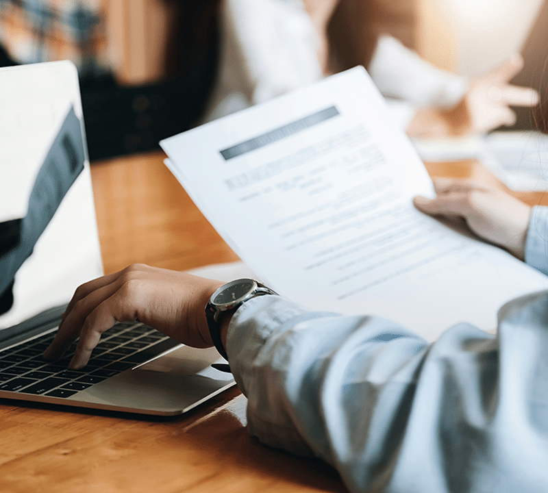 How to Verify a Cash Home Buyer Is Legitimate: Step-by-Step Checklist 4 Person working on laptop with documents