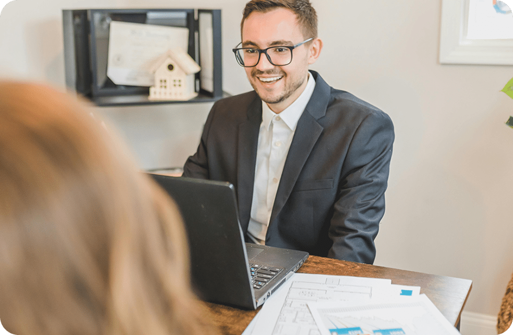 What Is a Wholesaler vs. a Cash Buyer? (And Why It Matters to You) 5 Business meeting with laptop and documents.