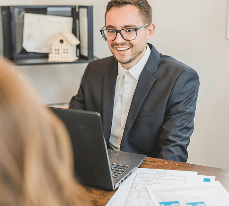 What Is a Wholesaler vs. a Cash Buyer? (And Why It Matters to You) 5 Business meeting with laptop and documents.