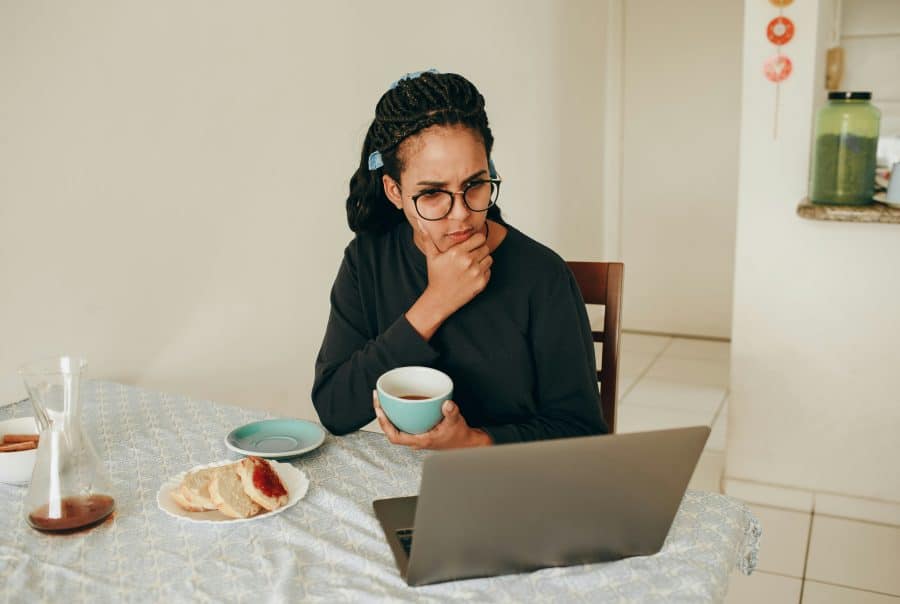 Woman thinking while using laptop